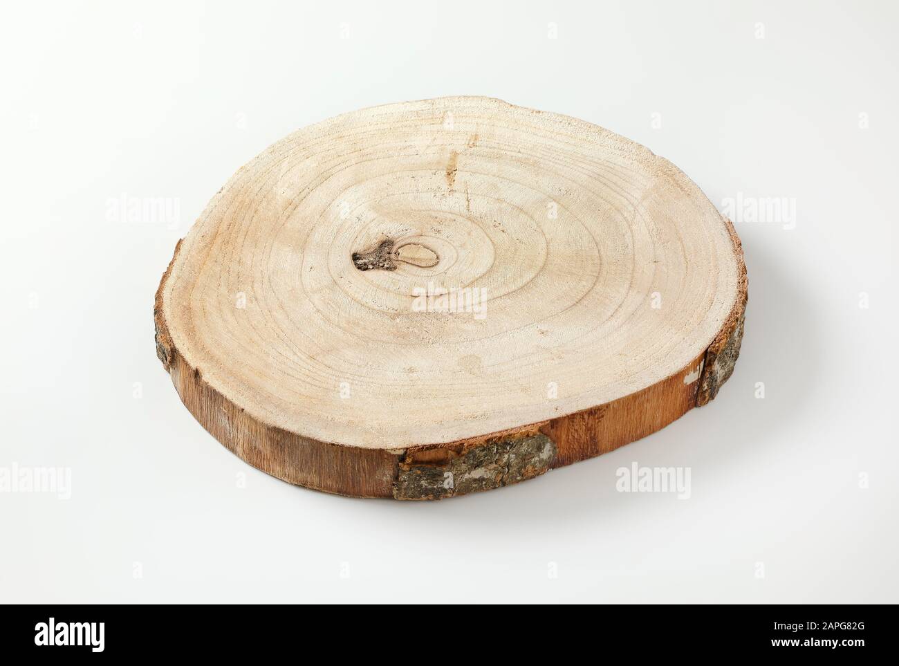 Natural live edge round wood slab with growth rings Stock Photo