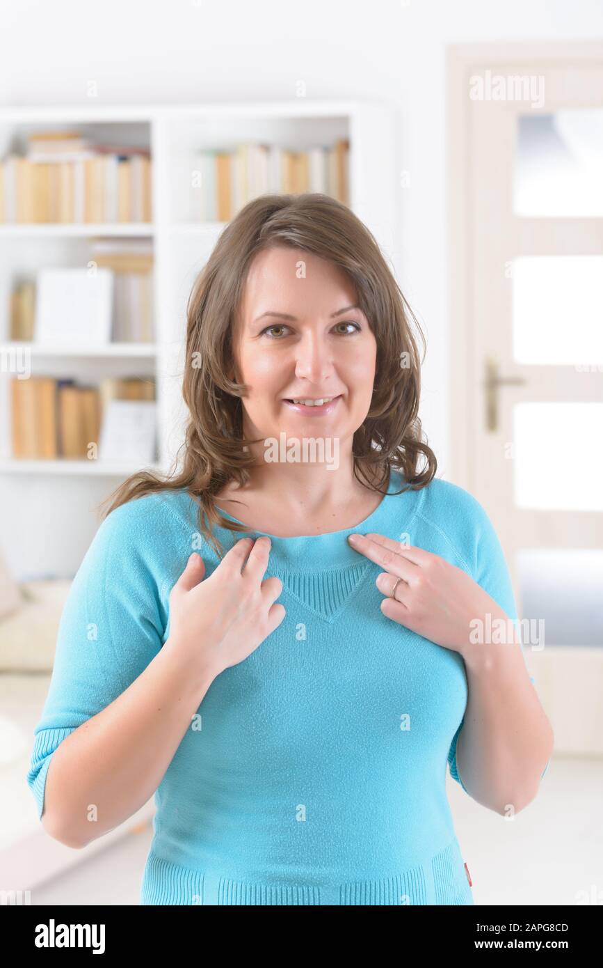 Woman doing EFT on the under collarbone. Emotional Freedom Techniques, tapping, a form of counseling intervention that draws on various theories of al Stock Photo