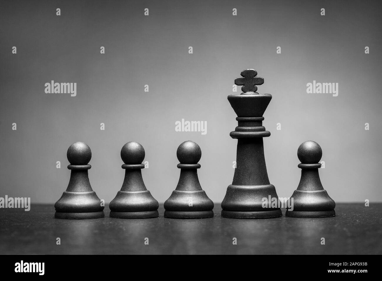 Black king chess piece with four pawns Stock Photo