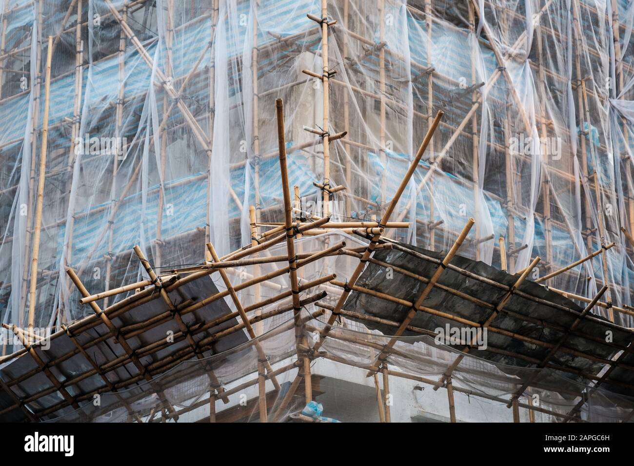 Bamboo scaffolding on building facade, construction site  - Stock Photo