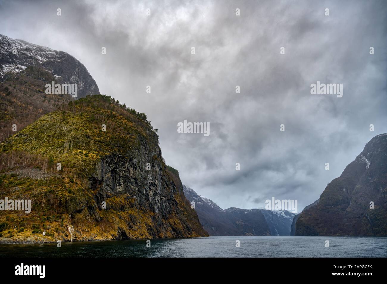 Naeroyfjord mountains under a cloudy sky in Norway Stock Photo - Alamy