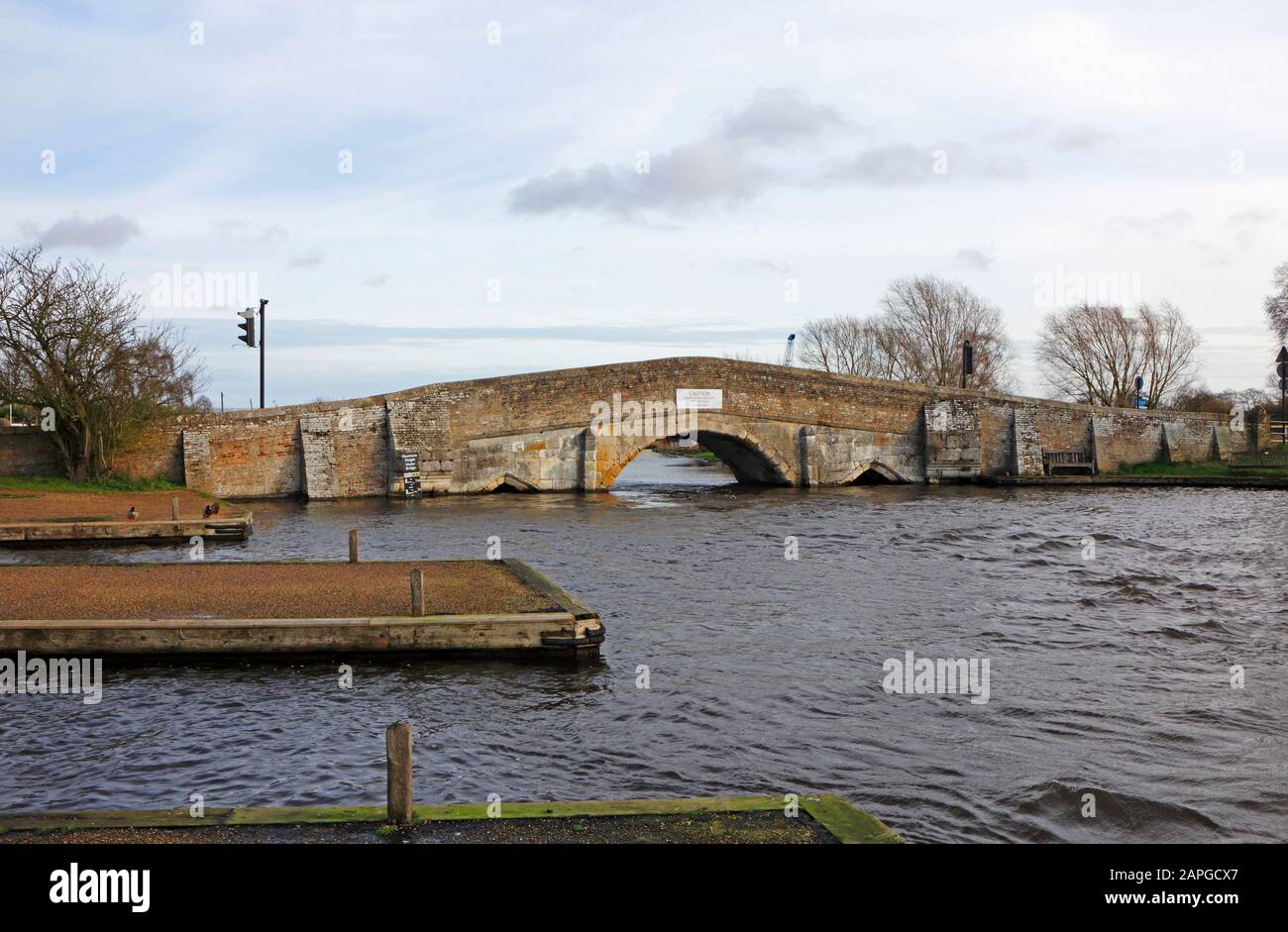 A view from the west bank of the old medieval bridge crossing the River Thurne on the Norfolk