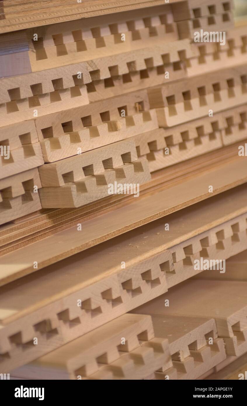 Vertical picture of lumber frames on top of each other under the lights