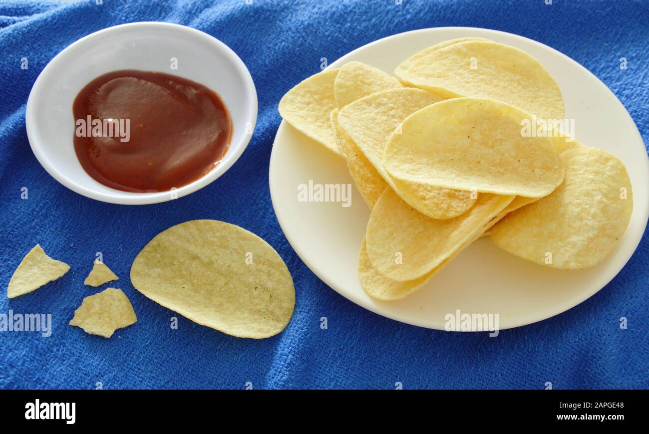 crispy and salt potato chips on dish dipping with ketchup Stock Photo