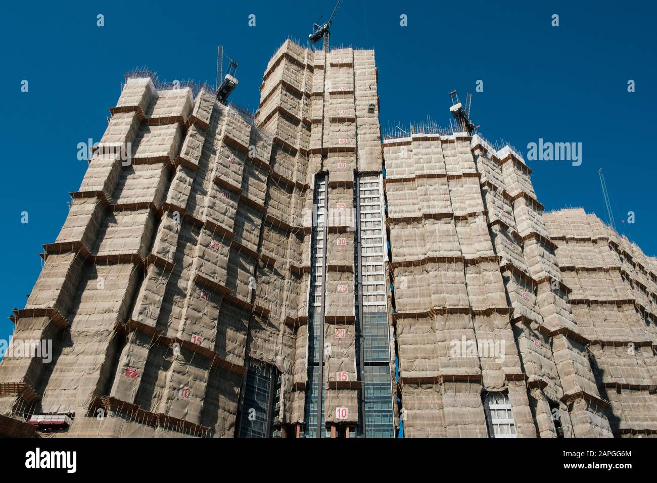 Bamboo scaffolding on building facade, bamboo pole framework, Stock Photo