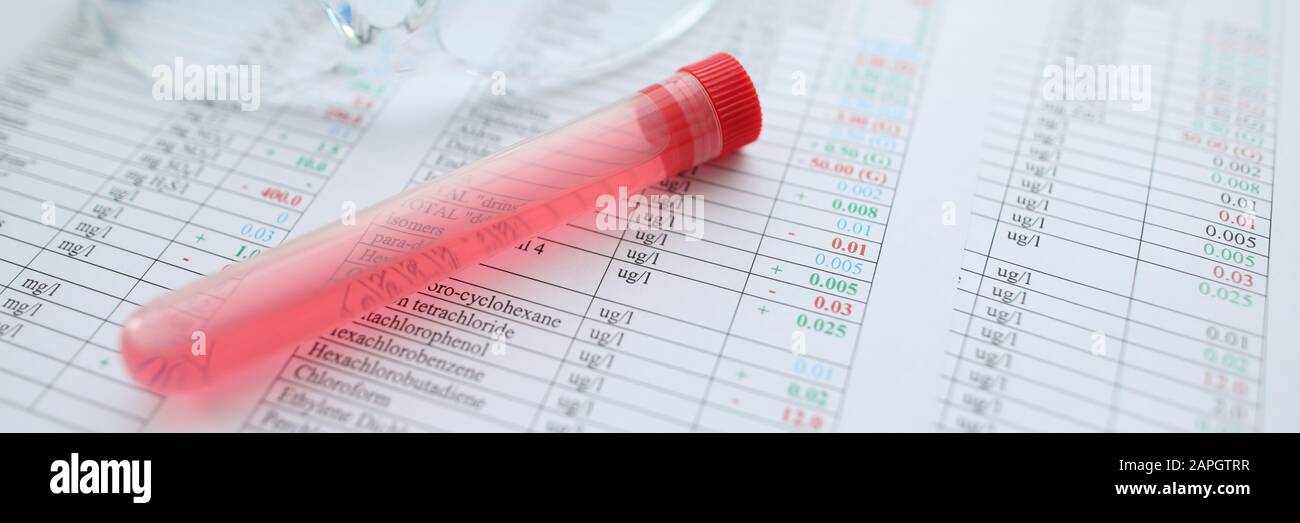 Testing tube with red liquid lying at chemical composition Stock Photo