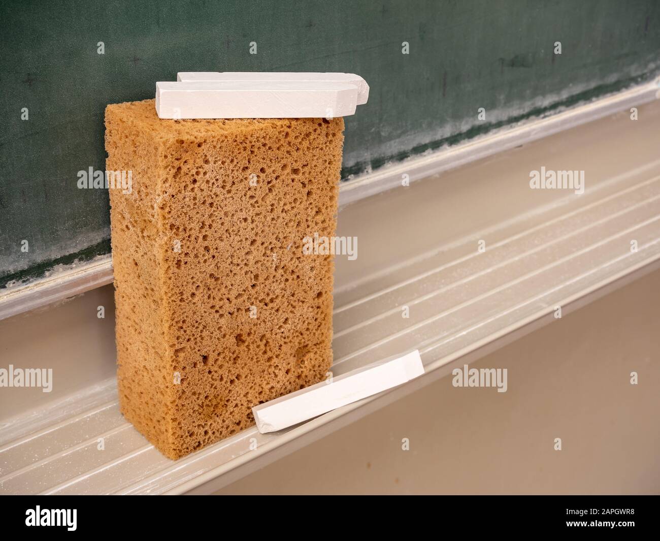 Blackboard sponge with chalk in the classroom Stock Photo