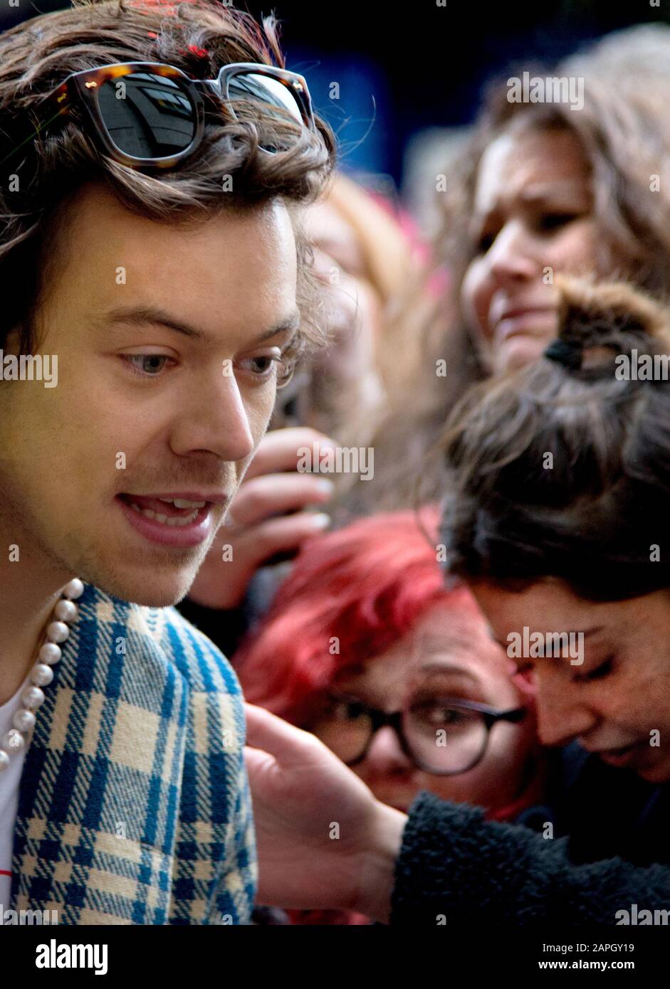 Harry Styles - One Direction Singer - meeting a large crowd of fans outside BBC Broadcasting House after doing an interview for Radio 1 to promote hi Stock Photo