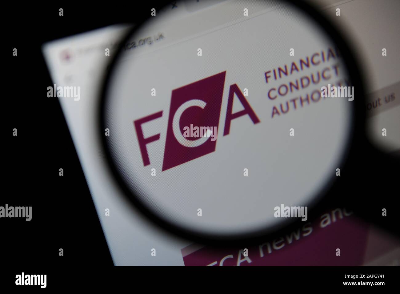 The Financial Conduct Authority website seen through a magnifying glass Stock Photo