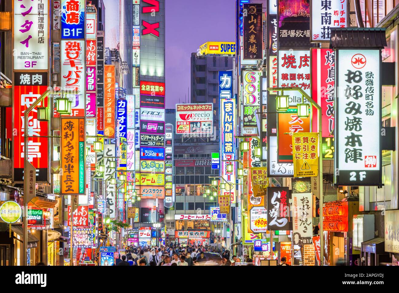 TOKYO, JAPAN - MAY 7, 2017: Crowds pass through Kabukicho in the Shinjuku district. The area is an entertainment and red-light district. Stock Photo