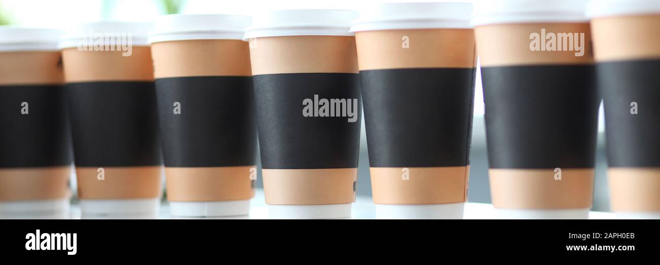 Line of paper cups standing at table Stock Photo - Alamy