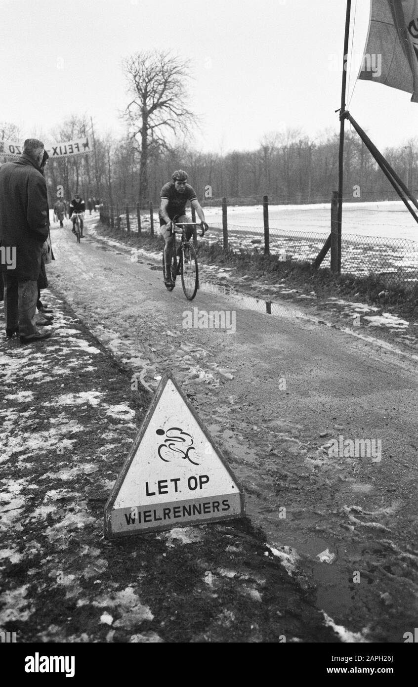 Cyclo-cross Katerrace 1969 on foreground sign Watch cyclists. Annotation: In the lead the later winner Cor Rutgers Date: 1 January 1969 Location: Den Haag, Loosduinen Keywords: signs, cyclist, cycling, cyclist Personal name: Rutgers, Cor Stock Photo