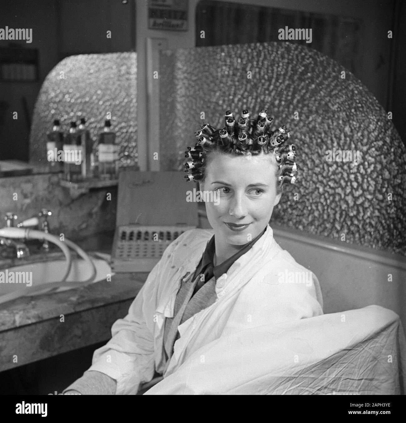 women's hair salons, customers, barberchairs, perms, curlers, EFA-Lock Date: November 1950 Keywords: women's hair salons, barberchairs, customers, curlers, perm person name: EFA- Lock Stock Photo