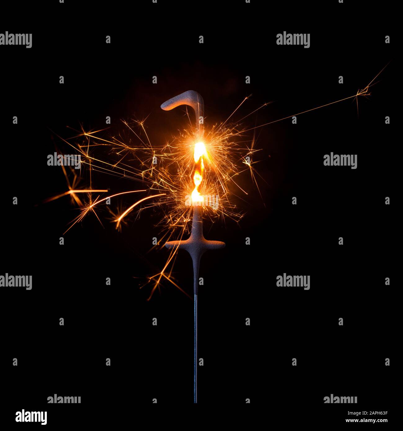 Burning sparkler in shape of number one, digit 1, isolated on black background. Stock Photo