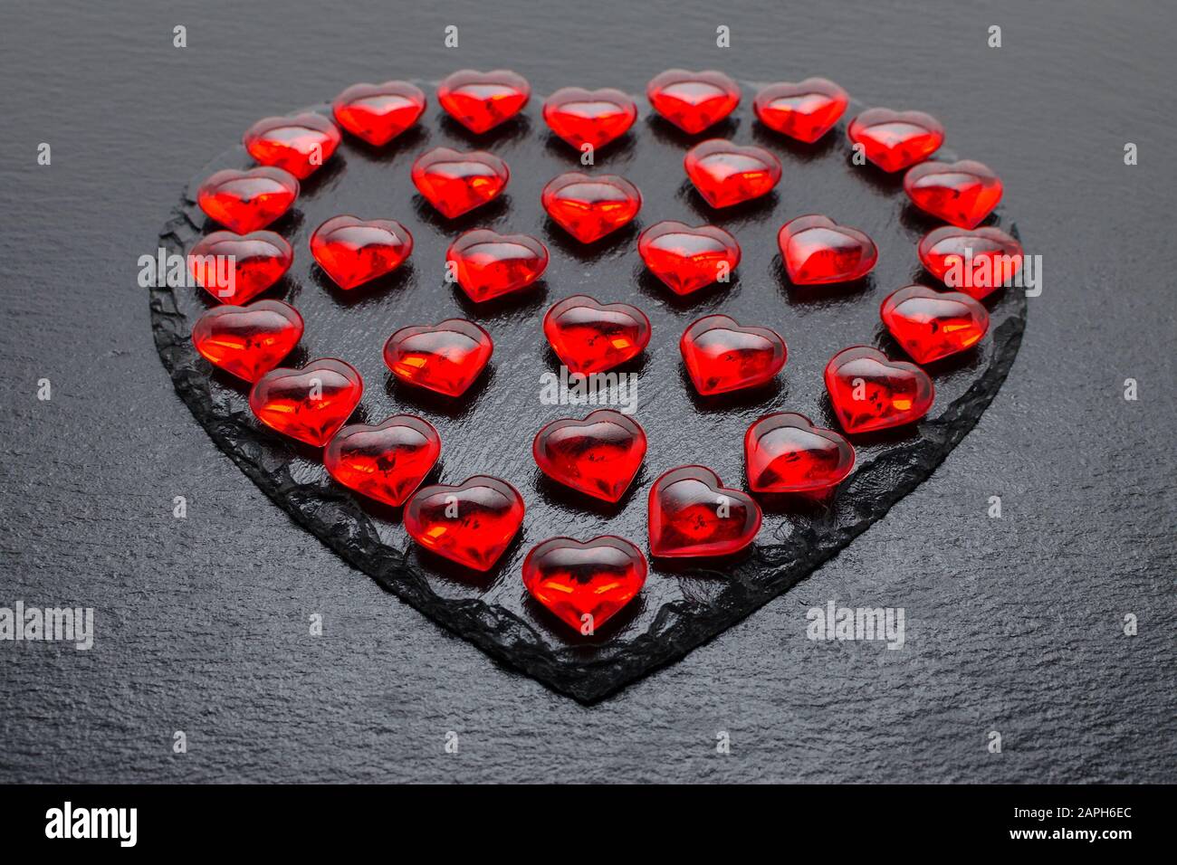 valentines day background with red hearts on black Stock Photo - Alamy