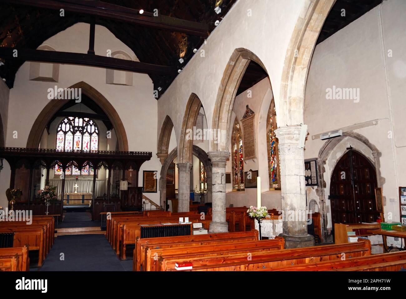 View east along nave towards choir and chancel inside St Mildreds church, south aisle and main entrance on right , Tenterden , Kent , England Stock Photo