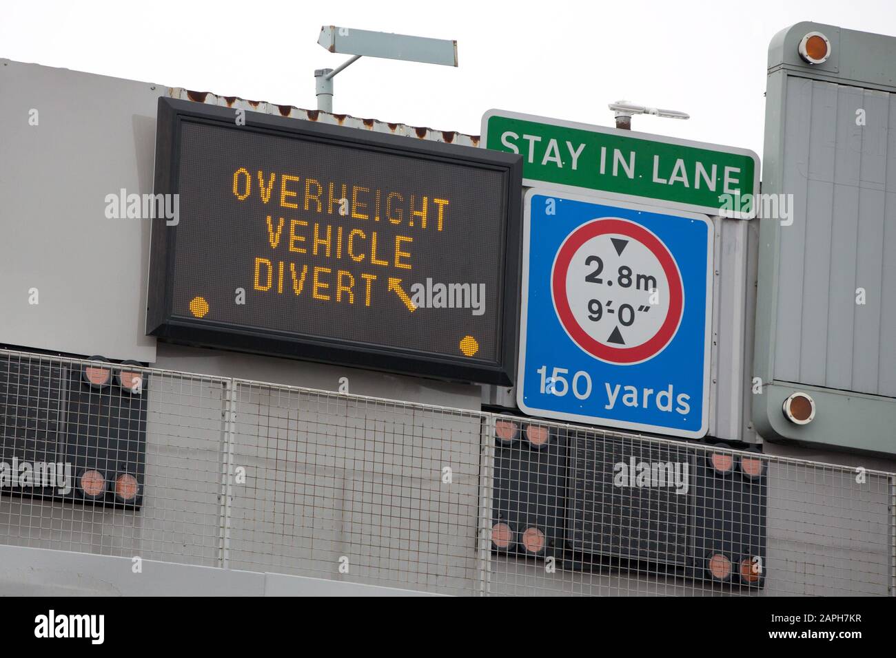 A dot matrix sign instructs an overheight vehicle to take a diversion at the approach to Blackwall Tunnel in London, England Stock Photo