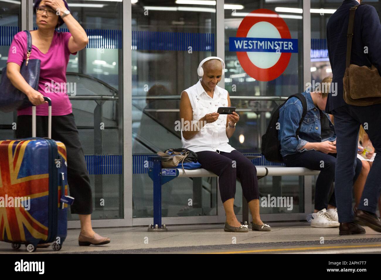 Wmata Using Phone A woman uses her smart phone at Westminster London Underground station ...