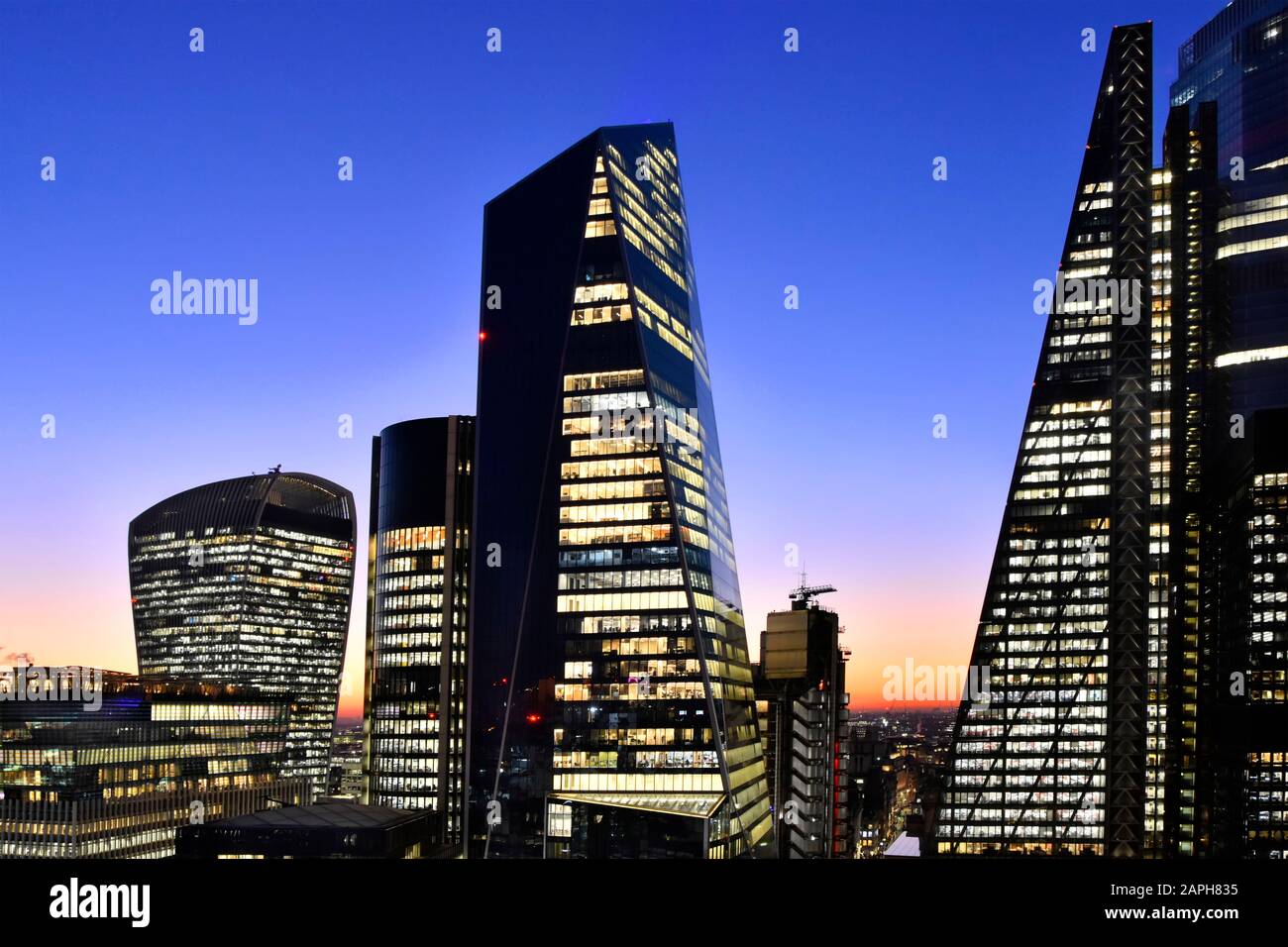 City of London cityscape skyscraper skyline & blue dusk winter sunset sky with office lights on Leadenhall building Lloyds Scalpel & Walkie Talkie UK Stock Photo