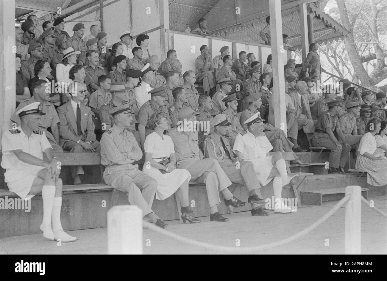 unknown Description: [British general E.C. Mansergh visiting a British Indian tank unit] Grandstand with guests, a.o. Lieutenant Governor General H.J. van Mook (with tropical helmet) and Admiral A.S. Pinke Date: 1946 Location: Indonesia, Dutch East Indies Stock Photo