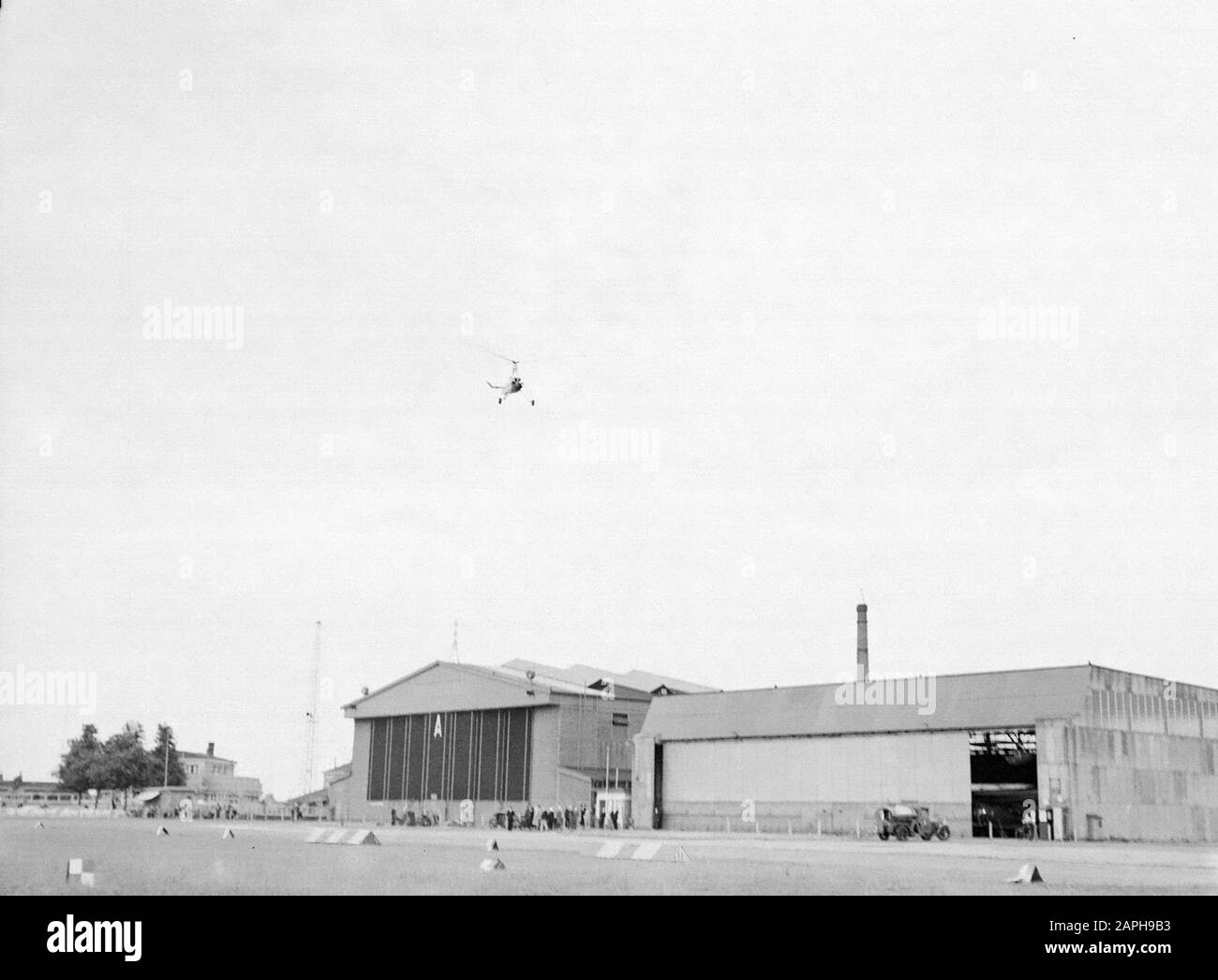 National Aviation School Holland Description: De Cierva autogiro PH-HHH called 'Donna Dulcinea' of the Dutch Aviation School flying over the hangars of the Rotterdam airport Waalhaven Annotation: The Dutch Aviation School was based in Rotterdam Waalhaven and Amsterdam Schiphol Date: 1935 Location: Rotterdam, Waalhaven Keywords: autogiro, special aircraft, hangars, airports Personal name: Cierva, Juan de Stock Photo