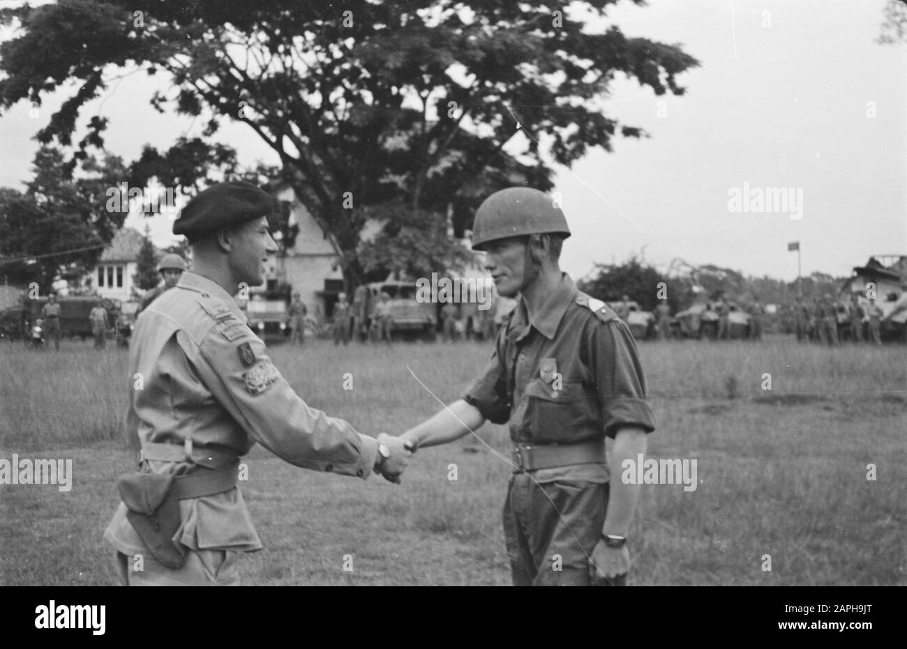 Salatiga. Celebration of the 134-year anniversary of the Hussars of Boreel by the 2nd Squadron Armored Cars Description: The Corps Commander, Major F. Rouffaer congratulates Adjutant O.O. H. de Jager with his bronze medal for 12 years of loyal service Date: 25 November 1947 Location: Indonesia, Java, Dutch East Indies, Salatiga Stock Photo