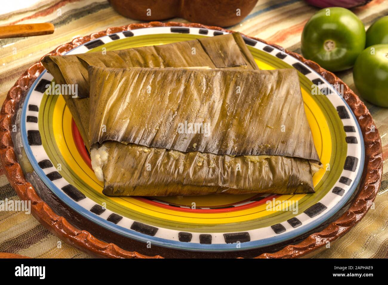 Tamales Oaxaqueños, Mexican dish made with corn dough, chicken or pork and chili, wrapped in a banana leaves. Stock Photo