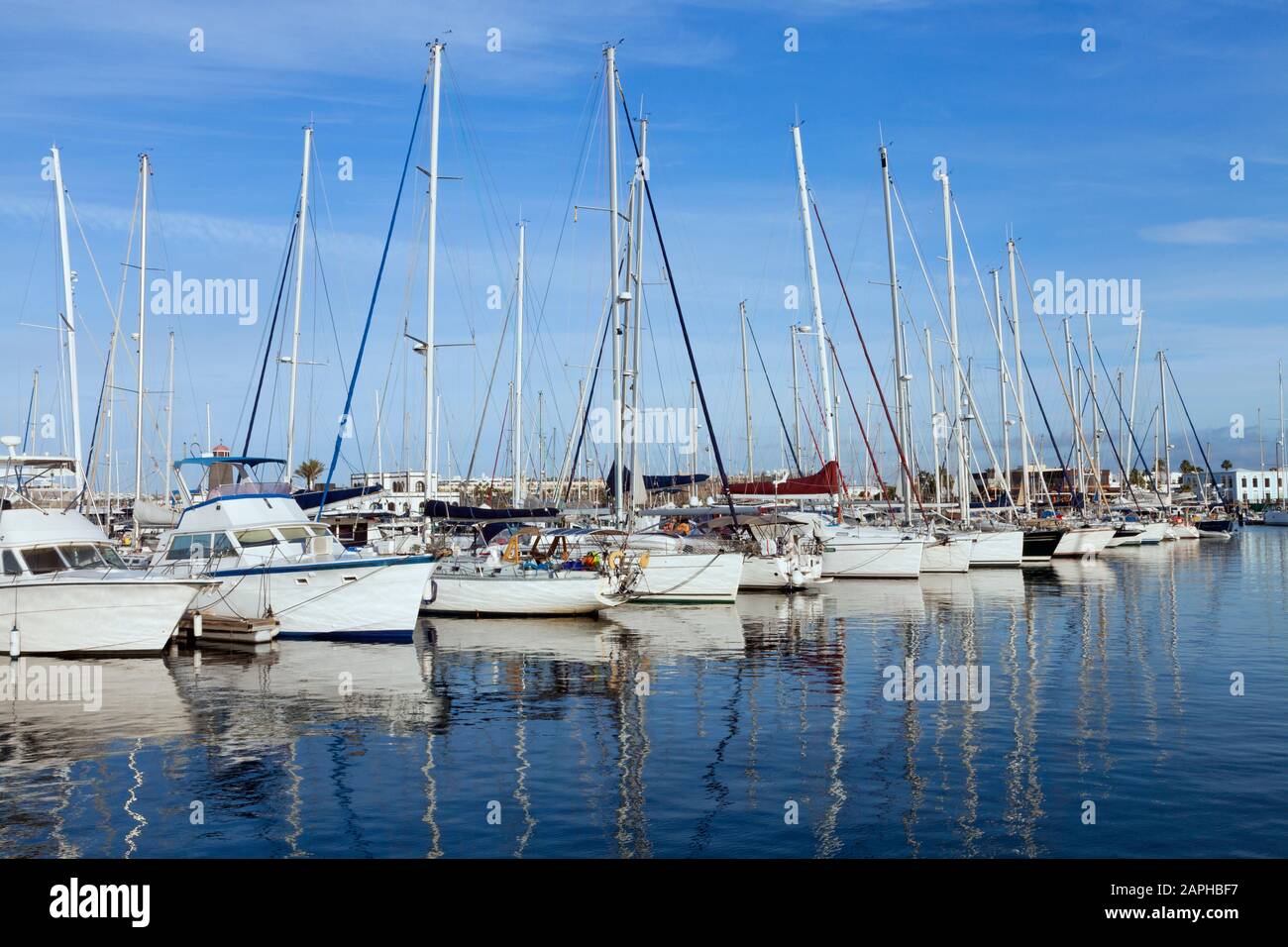 Sailing, fishing boats, yachts anchored in a small sea port, on a summer day . Stock Photo
