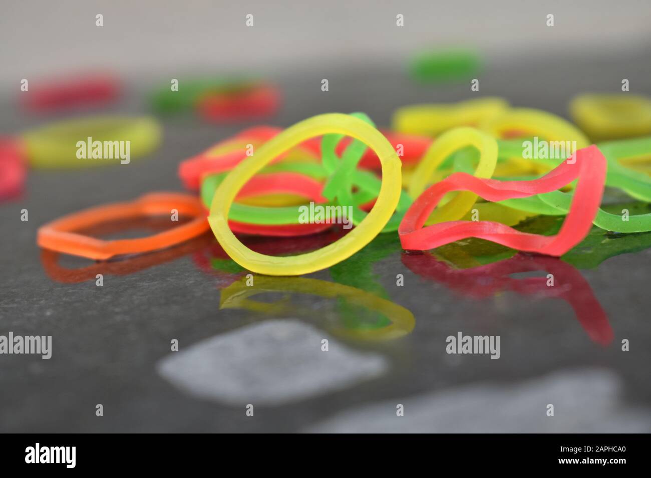 Colorful rubber bands in black background. Stock Photo
