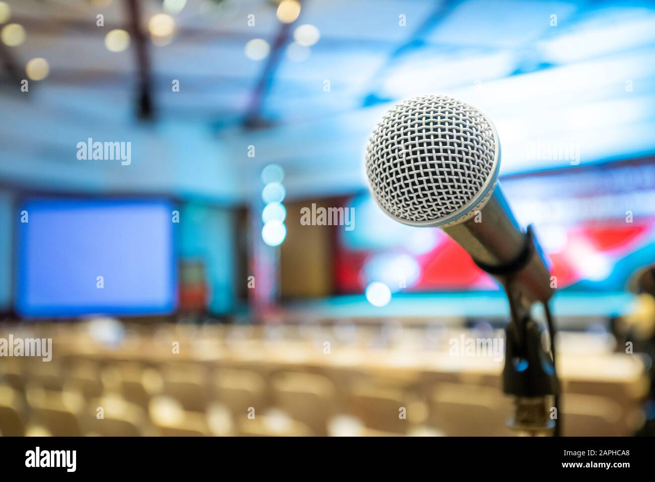 Microphone stand abstract blurred photo in conference hall or seminar