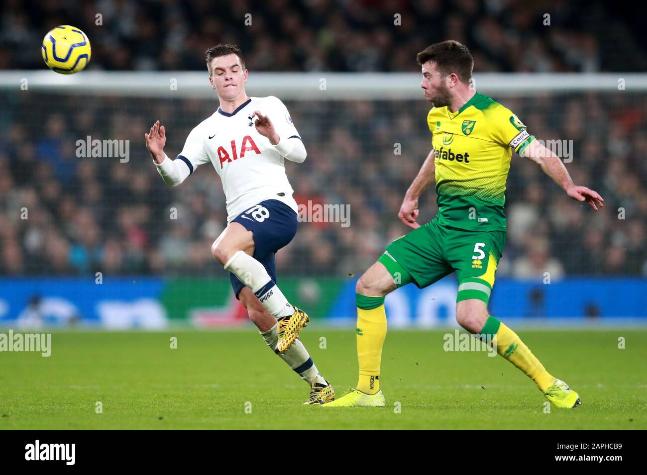 Tottenham Hotspur's Giovani Lo Celso (left) and Norwich City's Grant Hanley battle for the ball during the Premier League match at Tottenham Hotspur Stadium, London. Stock Photo