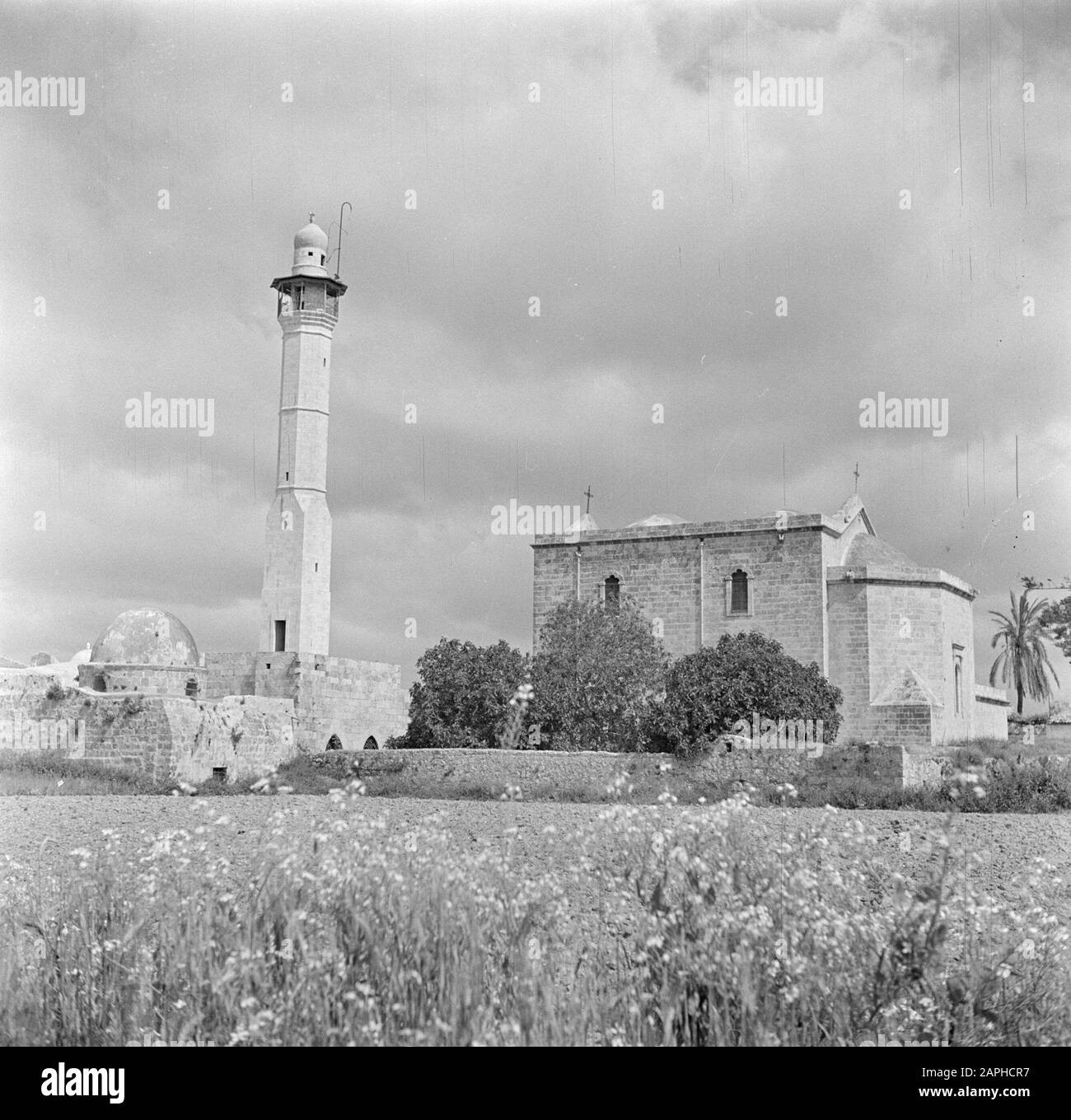 Israel 1948-1949: Lydda (Lod) Description: The Greek Orthodox St. Joris church (right) and the El Chodr mosque (left) Annotation: The houses of worship are part of the same building complex and share a common wall Date: 1948 Location: Israel, Lydda Keywords: churches, mosques, towers Stock Photo