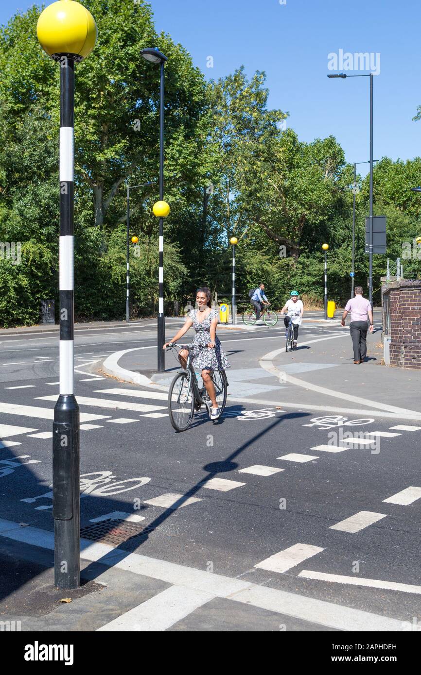 Cyclists in London using a special zebra crossing for bikes, on Scrubs Lane Stock Photo