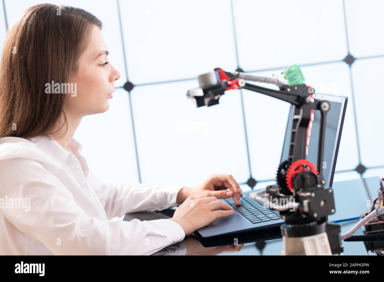 Woman student with robot model arm in university laboratory Stock Photo ...