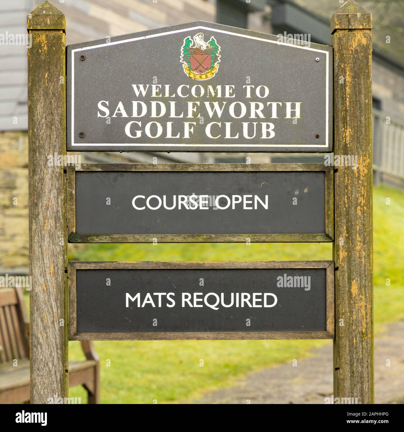 A sign reminding golfers at Saddleworth Golf Club that mats are reqyuired when playing in damp conditions. Stock Photo
