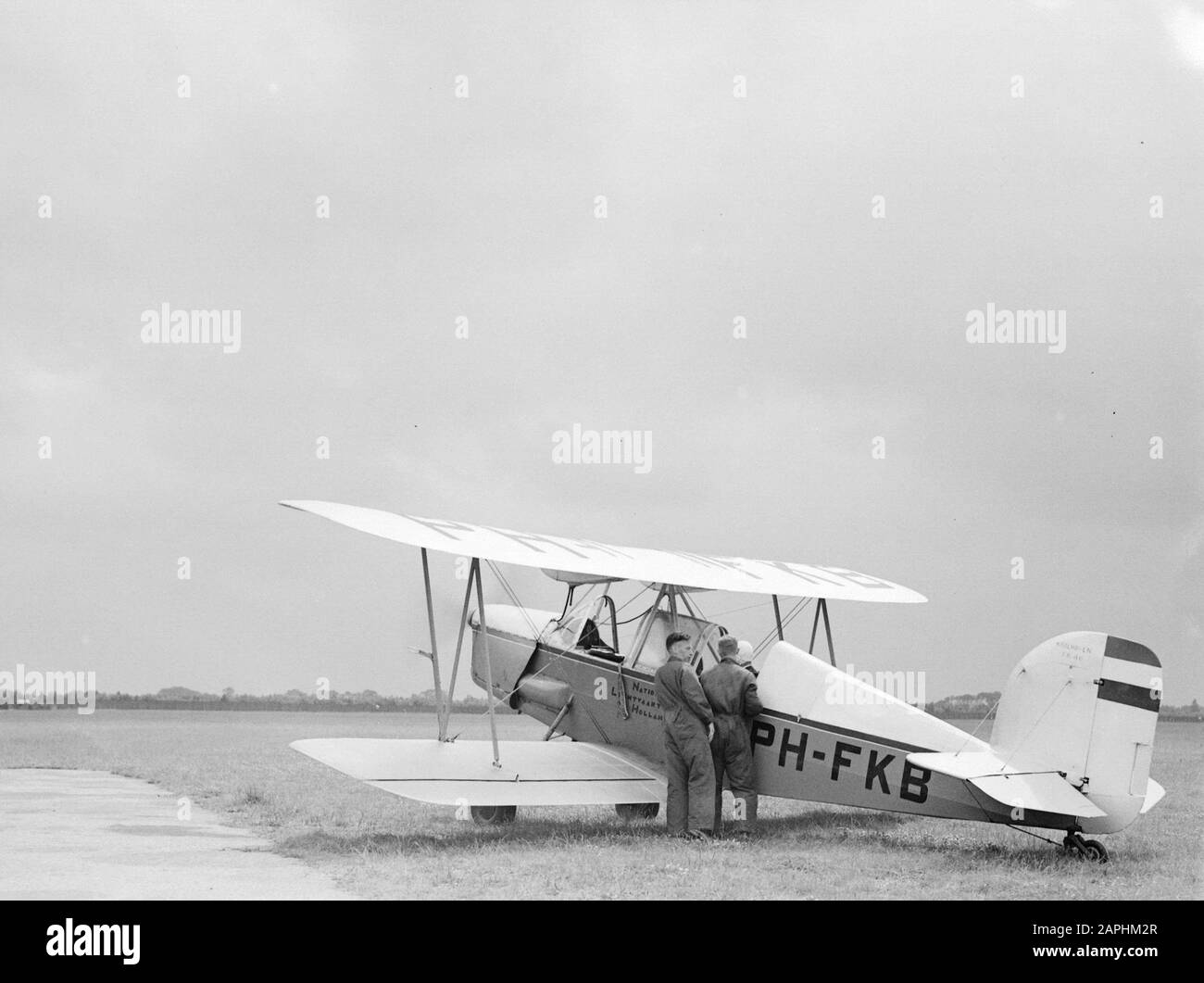 National Aviation School Holland Description: De Koolhoven FK-46 PH-FKB of the National Aviation School ready to depart from the Rotterdam airport Waalhaven. Two mechanics stand aside from the adspirant-pilot Date: 1935 Location: Rotterdam, Waalhaven Keywords: pilots, flight training, aircraft Personal name: Koolhoven Frits Stock Photo