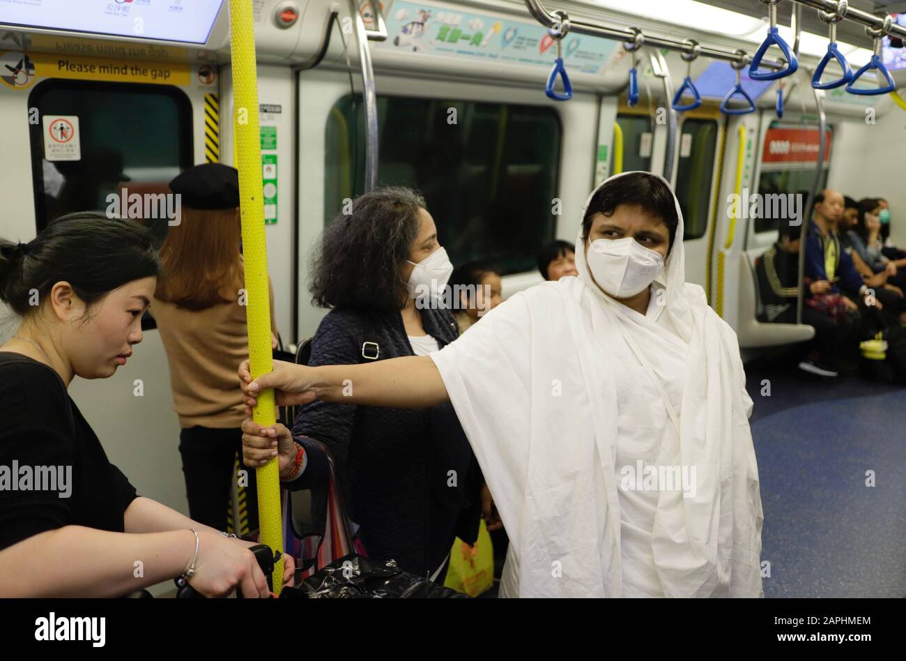 Hong Kong, China. 23rd Jan 2020. Two female visitors from Dubai ( centre ) and from India ( R ) put on surgical masks on the train to prevent from infection as Hong Kong is on high alert against rapidly spreading WUHAN PNEUMONIA, a new type of coronavirus which is threatening the City and putting millions of Hong Kong citizens at risk. Credit: Liau Chung-ren/ZUMA Wire/Alamy Live News Stock Photo