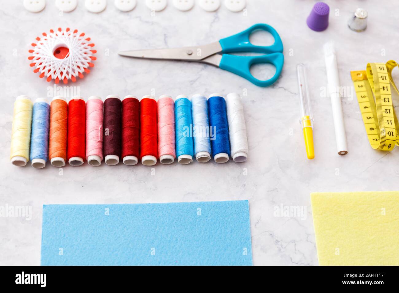 colorful sewing and tailoring tools and items on light background Stock Photo