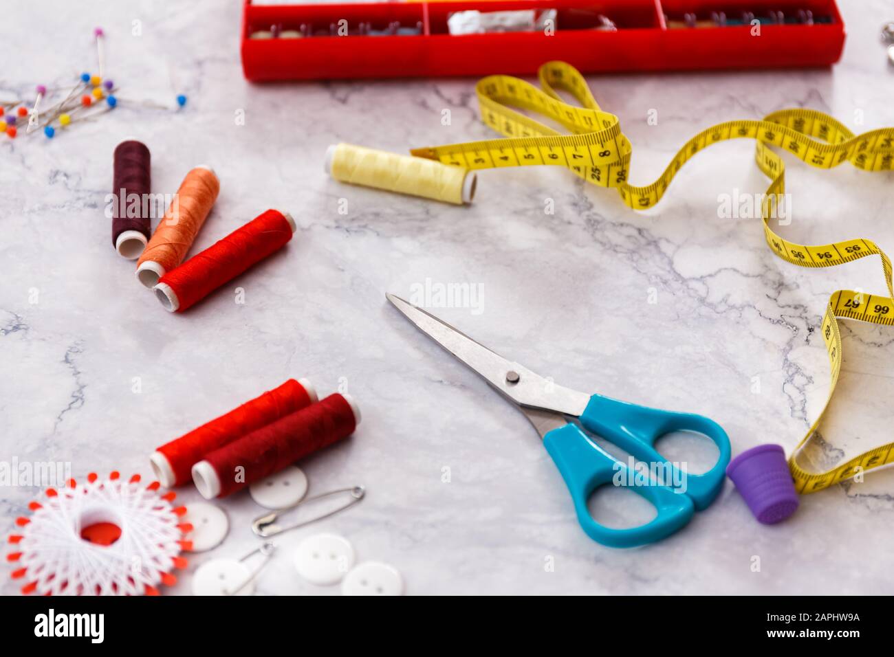 colorful sewing and tailoring tools and items on light background Stock Photo
