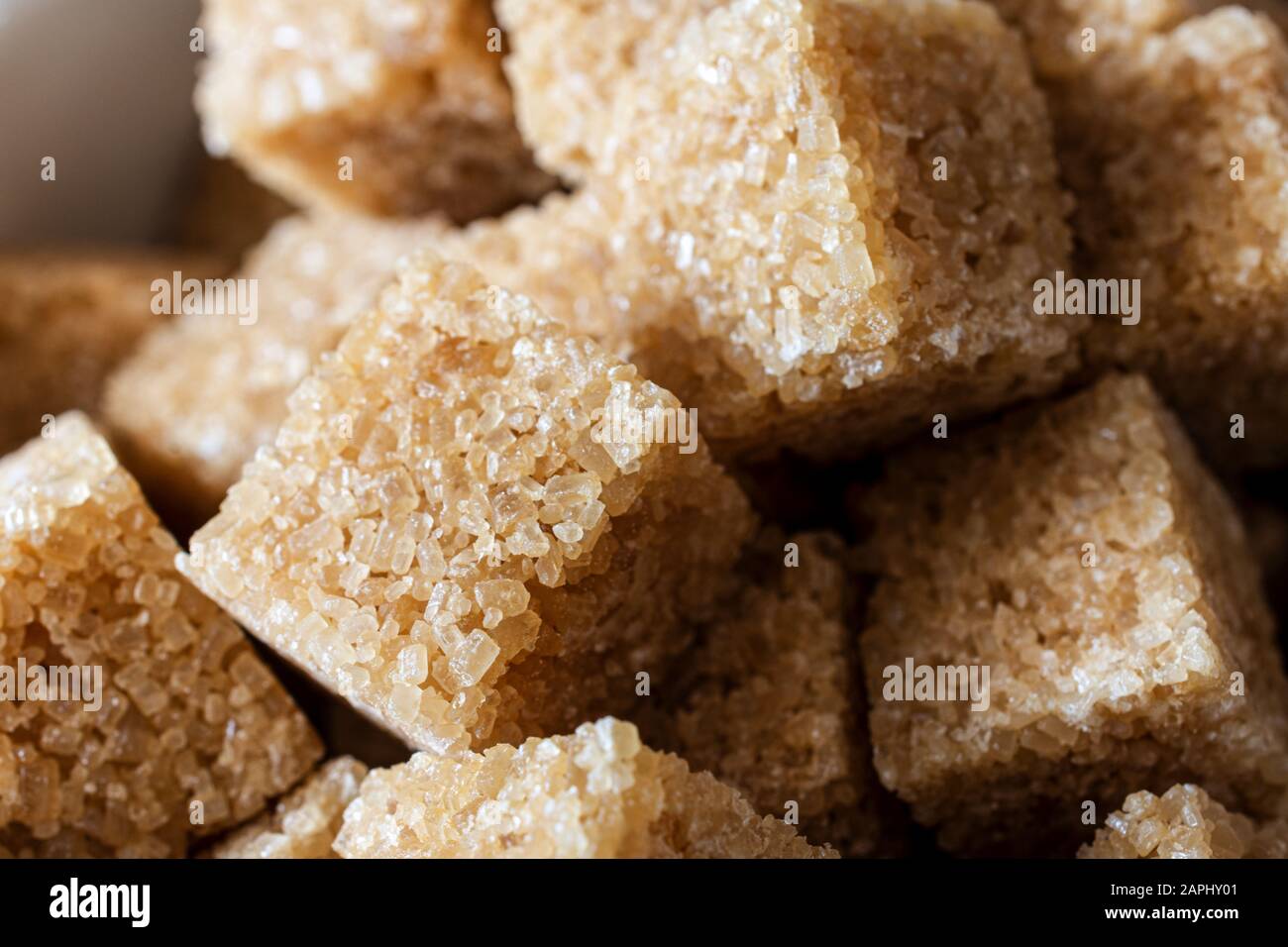 Close up (macro) shot of brown sugar cubes piled together. Stock Photo