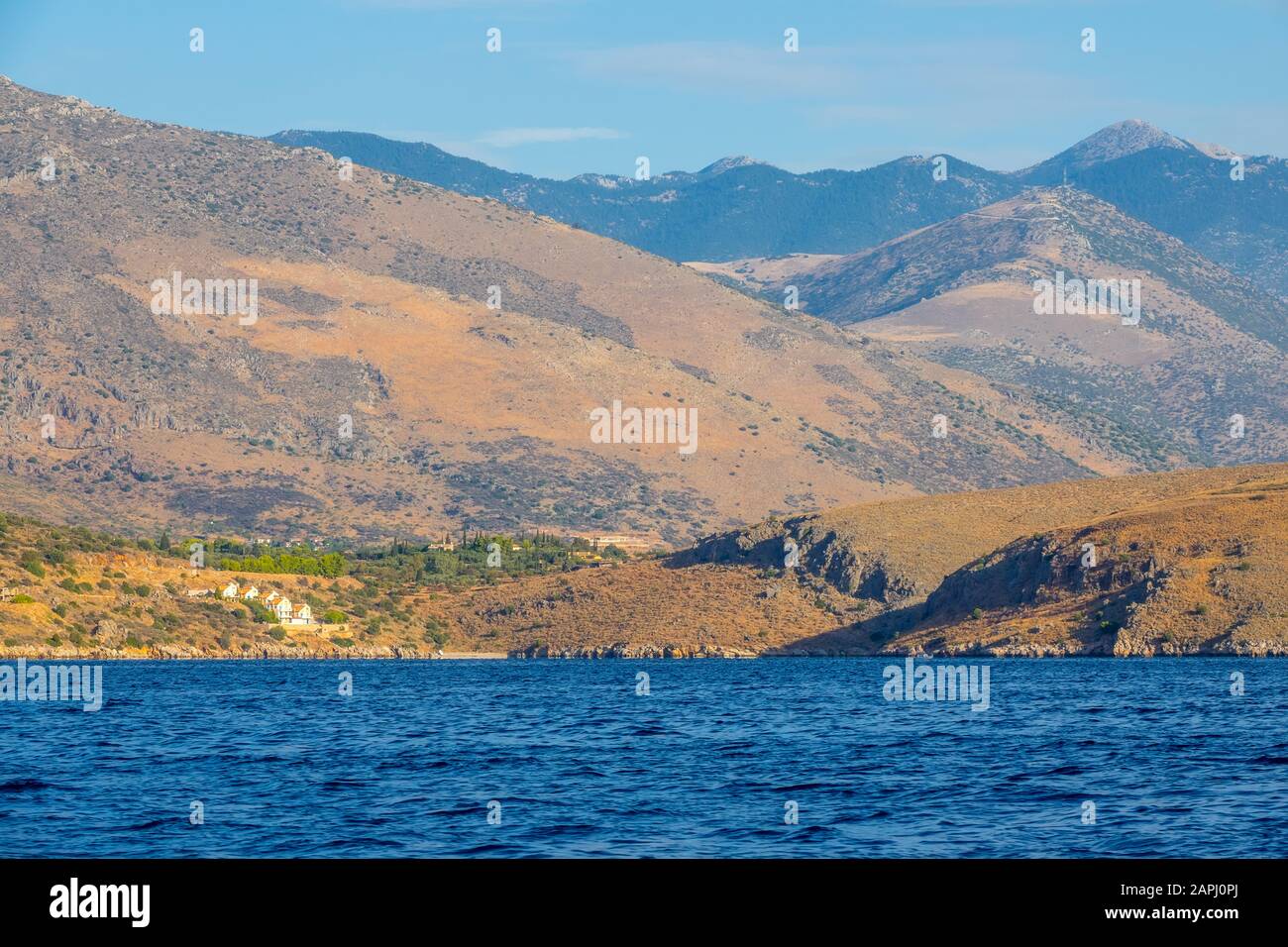 Greece. The hilly coast of the Gulf of Corinth. Summer day. Several cottages on the slope of a hilly coast Stock Photo