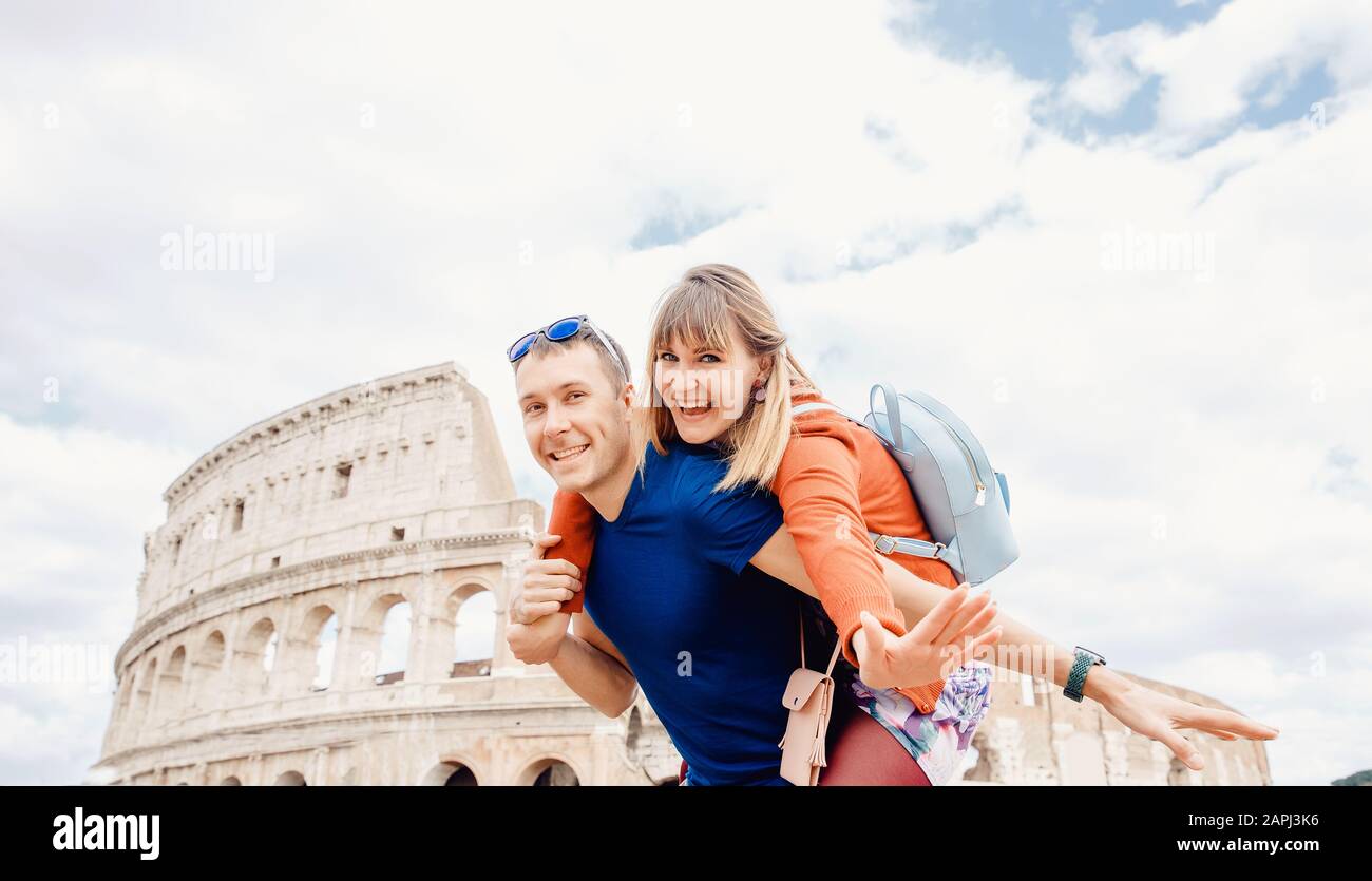 Travel couple man and girl taking selfie photo Colosseum landmark in Rome city. Concept europe Italy summer, people smiling Stock Photo