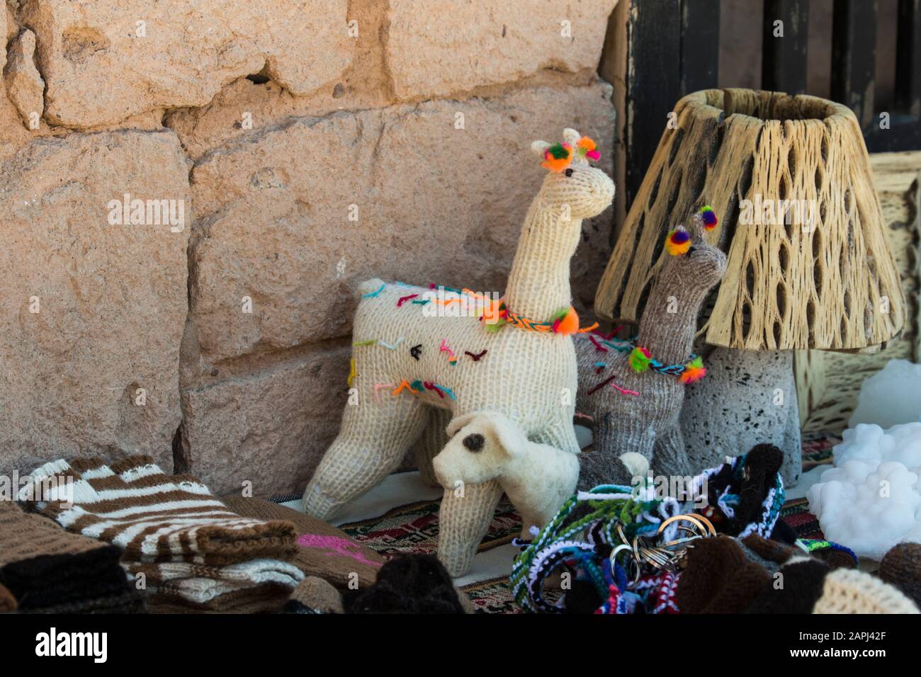 Toy llamas and other items for sale at an outdoor market in Chile Stock Photo