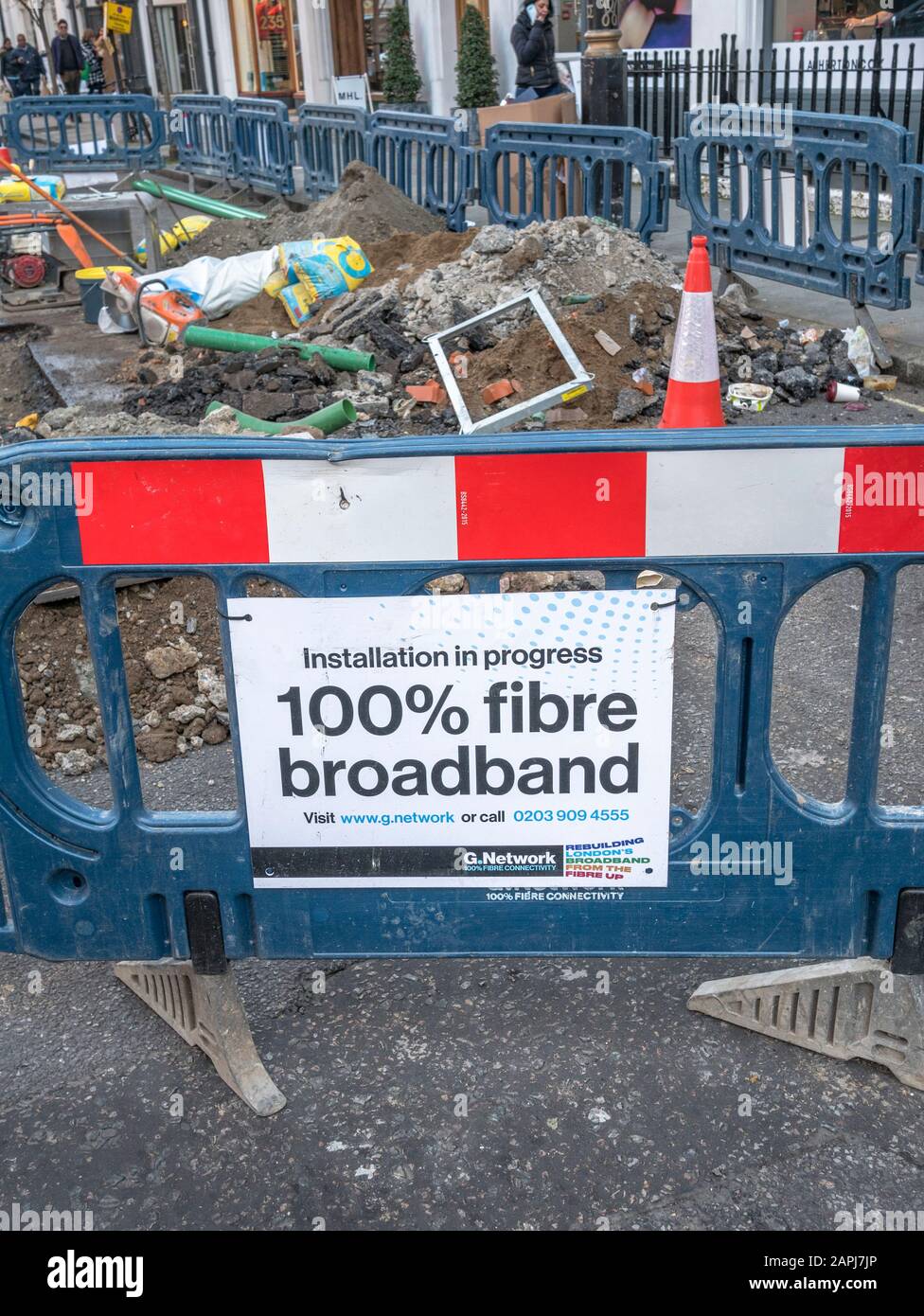 G.Network construction site pedestrian barrier in Marylebone side street, London, as 1Gbps BB fibre infrastructure is installed under the city. Stock Photo