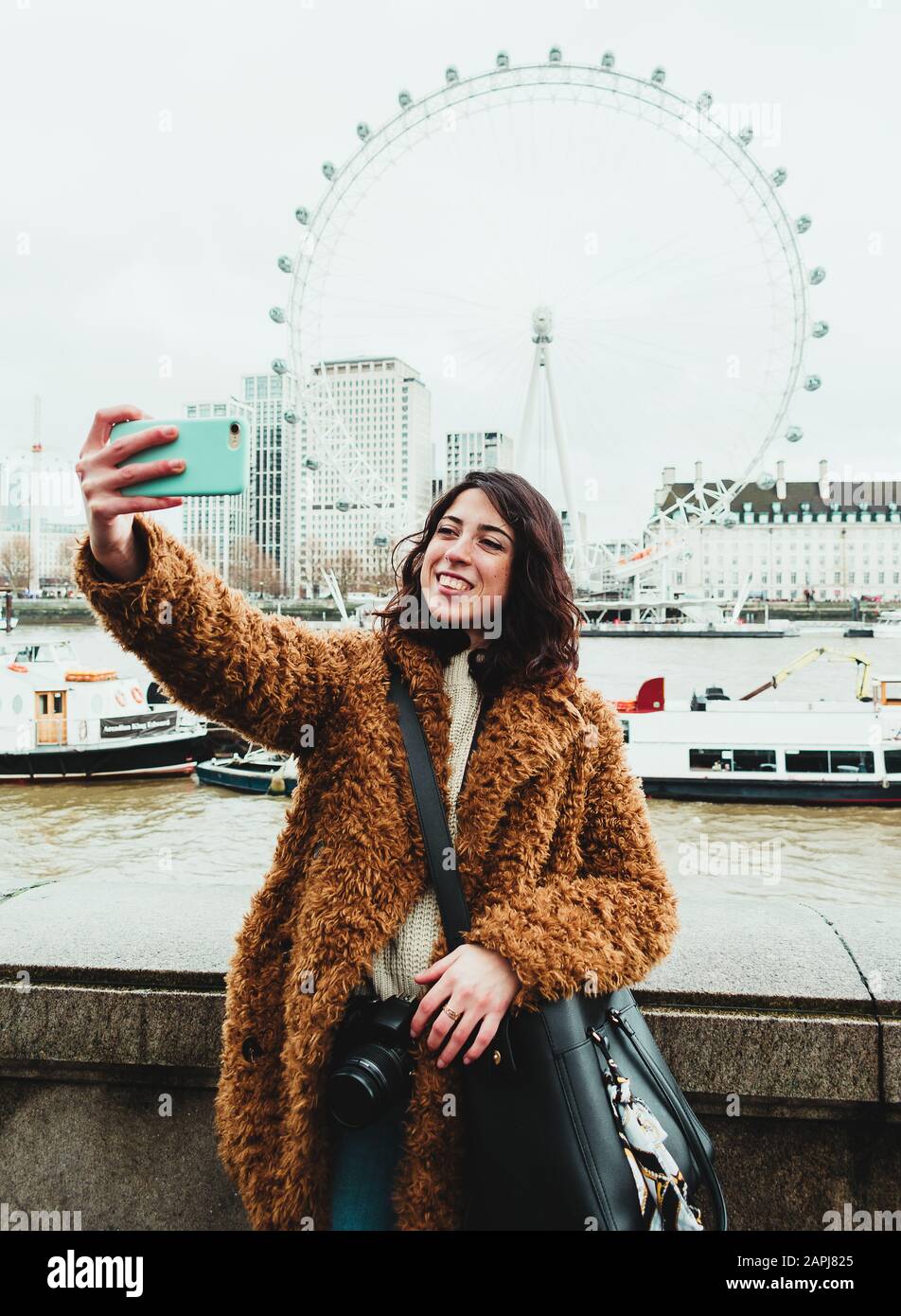 Young woman taking a selfie with the London Eye in the background Stock Photo
