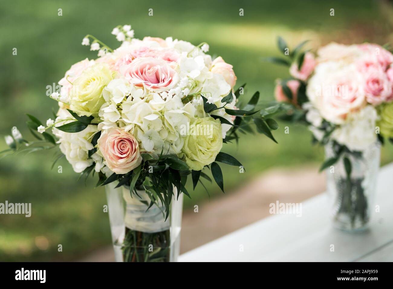 Floral bouquet of white, green and pink in vase before wedding ceremony Stock Photo