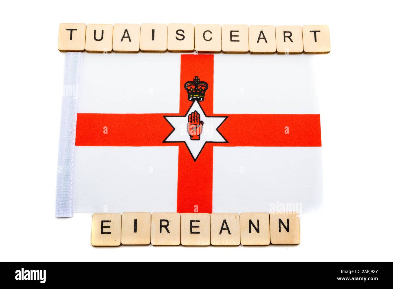 The national flag of Northern Ireland on a white background with a sign reading Tuaisceart Eireann, Northern Ireland in Irish Stock Photo
