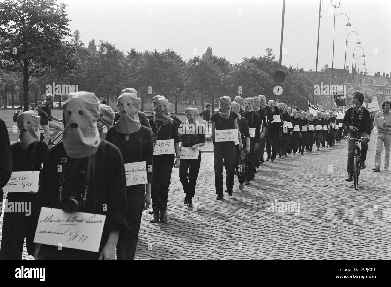 Demonstration in Amsterdam for a hundred missing artists Description: Protesters in Amsterdam, with hoods on, perform in parade with signs showing the names of 100 missing artists Date: September 12 1981 Location: Amsterdam, Noord-Holland Keywords: artists, demonstrations, signs Stock Photo