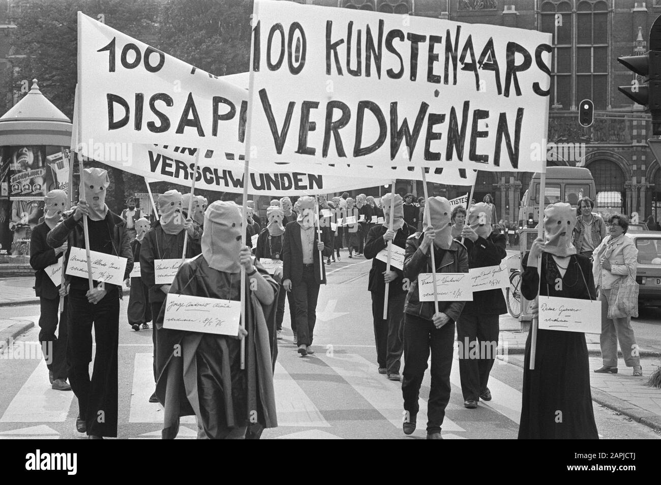 Demonstration in Amsterdam for a hundred missing artists Description: Protesters in Amsterdam, with hoods on, carrying banners and signs with the names of 100 missing artists Date: 12 September 1981 Location: Amsterdam, Noord-Holland Keywords: artists, demonstrations, signs, banners Stock Photo
