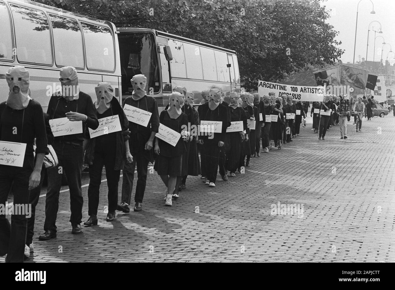Demonstration in Amsterdam for a hundred missing artists Description: Protesters in Amsterdam, with caps on, carry signs showing the names of 100 missing artists Date: September 12, 1981 Location: Amsterdam, Noord-Holland Keywords: artists, demonstrations, signs Stock Photo